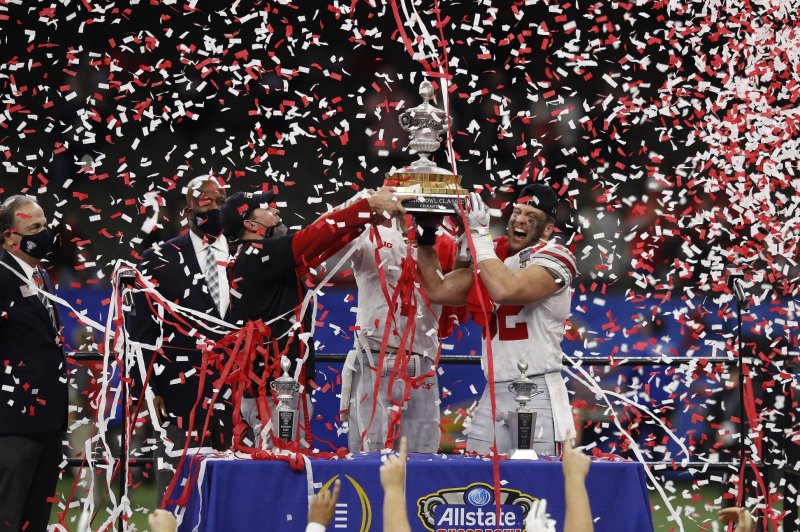 Ohio State Buckeyes head coach Ryan Day (L), quarterback Justin Fields (1) and linebacker Tuf Borland (R) celebrate with the Sugar Bowl Classic trophy after defeating Clemson 49-28 in the Sugar Bowl on Friday at the Mercedes-Benz Superdome in New Orleans. Photo by Aaron Josefczyk/UPI