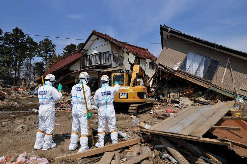 Japanese police wearing chemical protection suits search for victims inside the 20 kilometer radius around the Fukushima Daiichi nuclear power plant in Minamisoma, Fukushima prefecture, Japan, on April 15, 2011. A massive earthquake and ensuing tsunami on March 11 destroyed homes, killed thousands and caused a nuclear disaster. File photo by Keizo Mori/UPI
