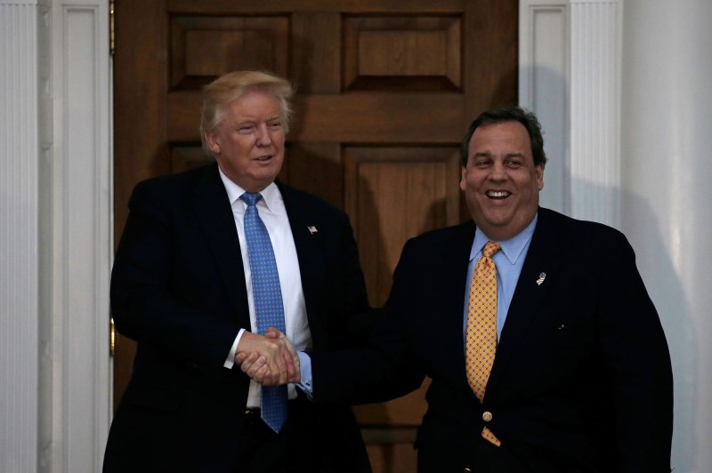 President-elect Donald Trump (L) shakes hands with New Jersey Gov. Chris Christie at the clubhouse of Trump International Golf Club in Bedminster, N.J., on Sunday. Christie said on his Monday radio show he intends to finish his term as governor, which ends in 13 months. Pool Photo by Peter Foley/UPI | <a href="/News_Photos/lp/e0f92022cbd7243897a7420312b46cbe/" target="_blank">License Photo</a>