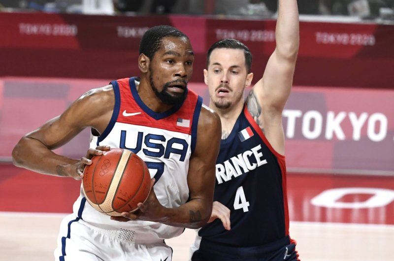 U.S. men's team forward Kevin Durant (L) drives against France's Thomas Heurtel during the men's basketball final Saturday at the 2020 Tokyo Olympics. Photo by Mike Theiler/UPI