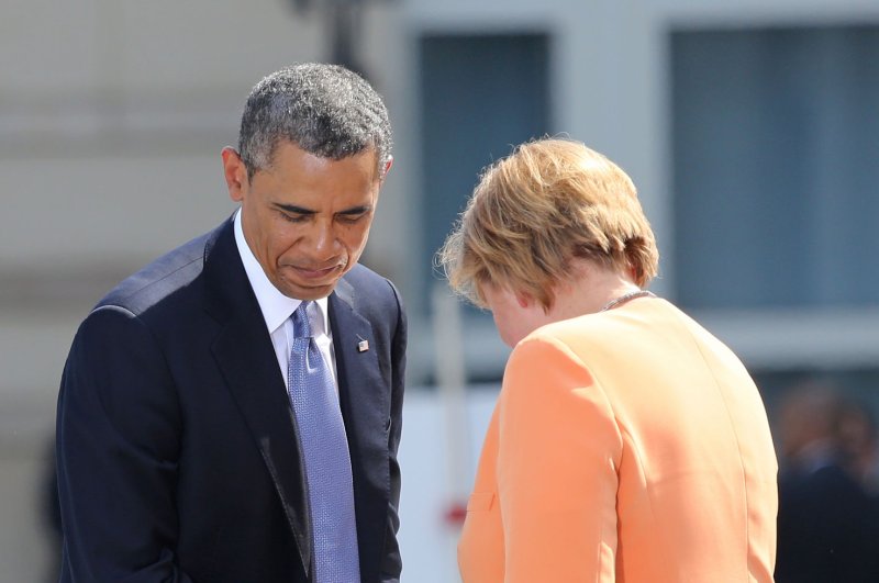 U.S. President Barack Obama shakes the hand of German Chancellor Angela Merkel after she finished her speech at the Brandenburg Gate in Berlin on June 19, 2013. UPI/David Silpa