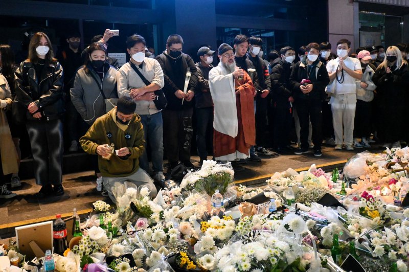 Mourners visit a makeshift memorial near the site of a crowd crush tragedy in Seoul on Oct. 31, 2022. The incident left more than 154 dead during Halloween celebrations in the nightlife district of Itaewon. File Photo by Thomas Maresca/UPI