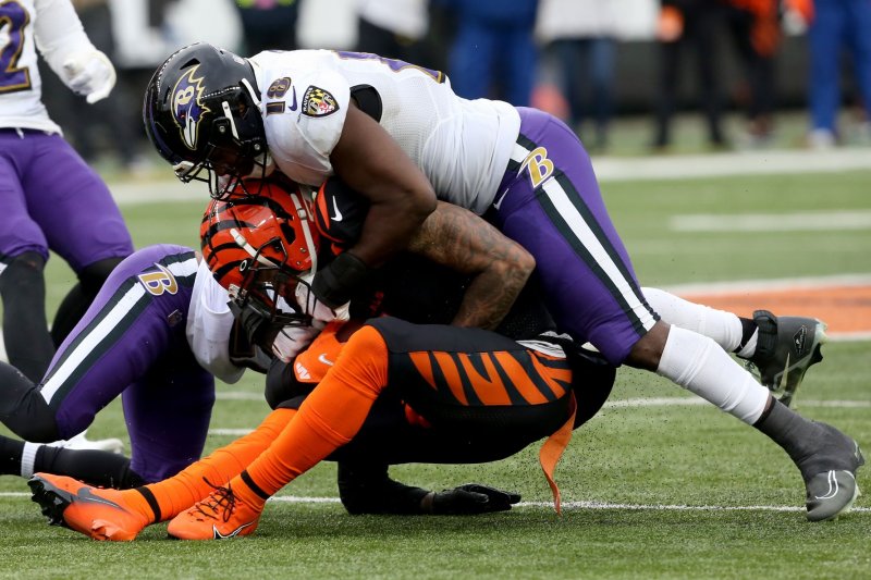 Cincinnati Bengals wide receiver JaMarr Chase (C) is tackled from behind by Baltimore Ravens linebacker Roquan Smith (R) on Sunday at Paycor Stadium in Cincinnati. Photo by John Sommers II/UPI