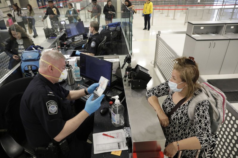 Officers with U.S. Customs and Border Protection Office of Field Operations screen international passengers arriving at Dulles International Airport in Dulles, Va., on March 13. Photo by Glenn Fawcett/U.S. Customs and Border Protection/UPI