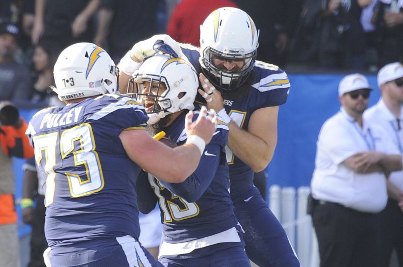 Los Angeles Chargers Keenan Allen is congratulated by teammates after recovering a fumble and running it in for a touchdown against the Oakland Raiders in the first half at StuHub Center in Carson, California on December 31, 2017. Photo by Lori Shepler/UPI