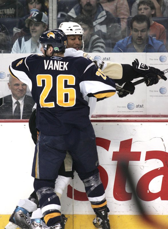 Pittsburgh Penguins right wing Georges Laraque is checked into the glass by Buffalo Sabres left wing Thomas Vanek (26), in Buffalo, N.Y., Feb. 17, 2008. (UPI Photo/Jerome Davis)