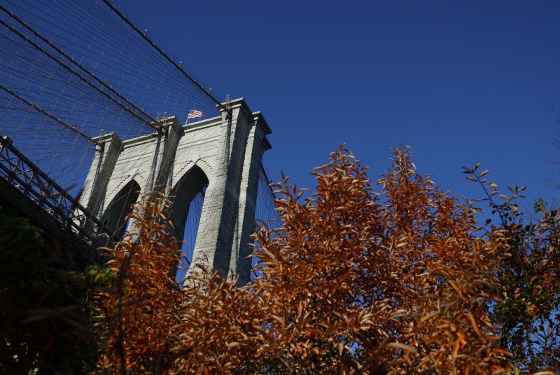 Trees show their seasonal colors near the Brooklyn Bridge in New York City on Thursday. Northern areas of New York could see small accumulations of snow this weekend. Photo by John Angelillo/UPI