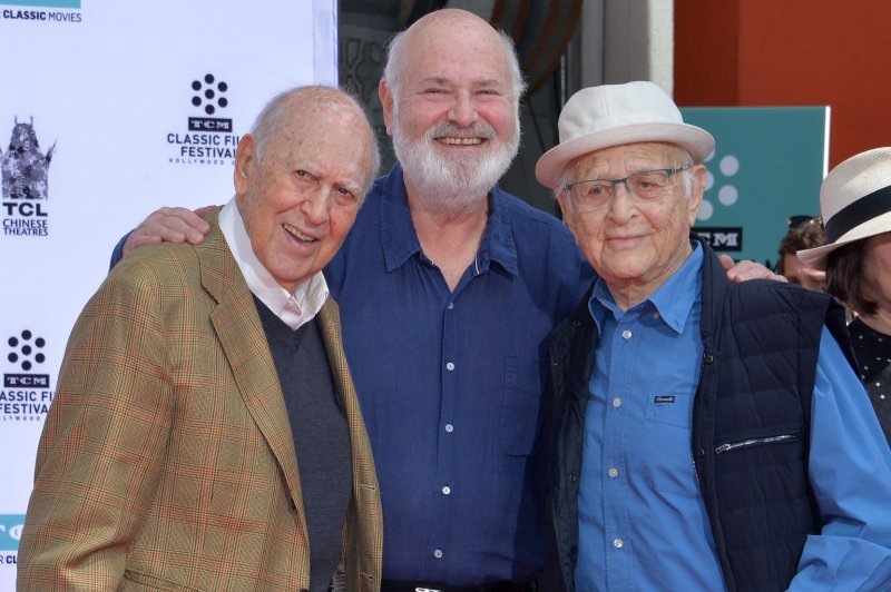 Left to right, Carl Reiner and Rob Reiner are joined by Norman Lear during a father and son double hand and footprint ceremony in 2017. Stars paid tribute to Lear on Wednesday following his death. File Photo by Jim Ruymen/UPI
