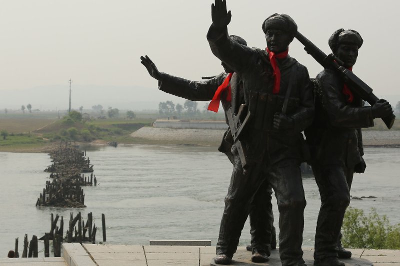 A Chinese patriotic statue pays tribute to a destroyed bridge connecting China and North Korea (background) during the Korean War, in Dandong, China's largest border city with North Korea. China and North Korea have been airing complaints of the other’s policies in the wake of recent sanctions that target Pyongyang’s weapons program. File Photo by Stephen Shaver/UPI