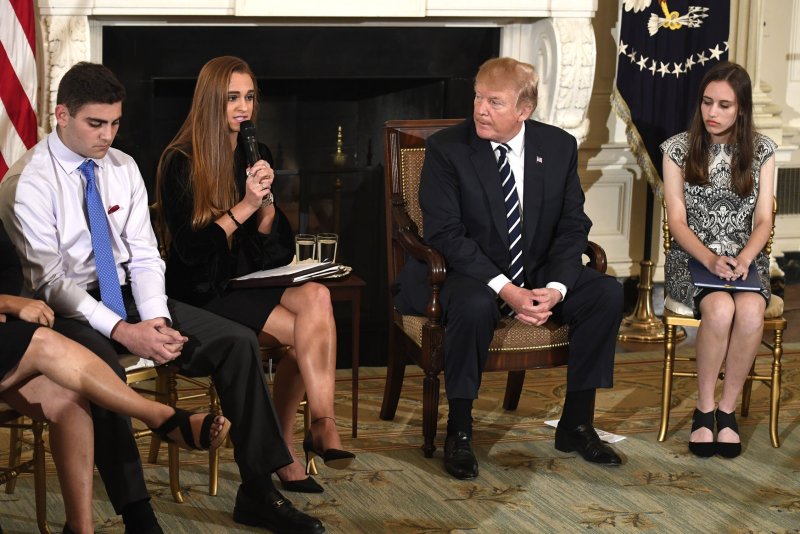 President Donald Trump (2nd-R) listens to Marjory Stoneman Douglas High School student body President Julia Cordover as surviving students attend a listening session on school violence at the White House on Wednesday. Photo by Mike Theiler/UPI