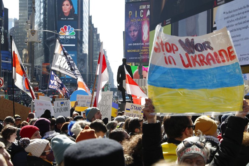 Protesters hold the flag of Ukraine as they show support at a Stand With Ukraine Rally in Times Square in New York City on Saturday. More than 50,000 Ukrainians have fled their country since Russia invaded. Photo by John Angelillo/UPI | <a href="/News_Photos/lp/d985411e49769e325ea49e6ade154e73/" target="_blank">License Photo</a>