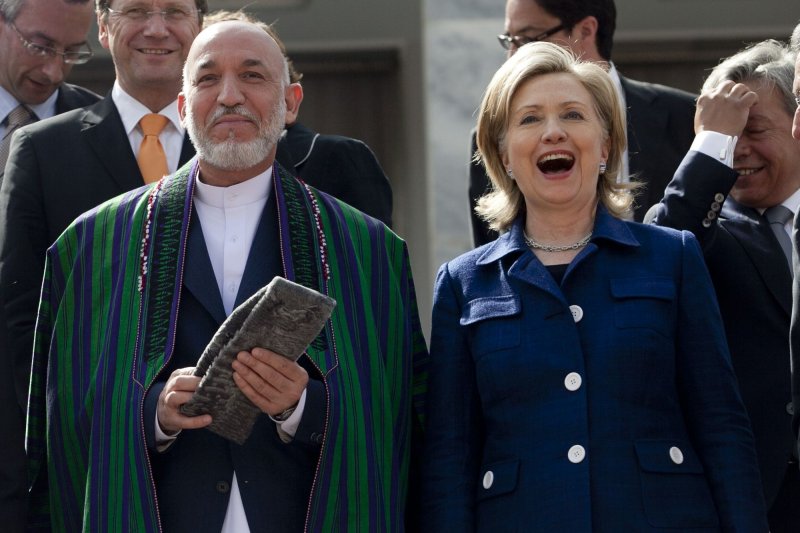 Afghan President Hamid Karzai and U.S. Secretary of State Hillary Clinton take part in a group photo at the conclusion of the International Conference on Afghanistan at the Foreign Affairs Ministry in Kabul, Afghanistan on July 20, 2010. The major international conference in Kabul called for at least 50 percent of development aid for the country to be channeled through the Afghan government's budget within two years. UPI/Hossein Fatemi