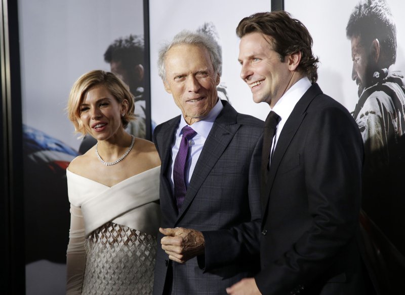 Sienna Miller, Clint Eastwood and Bradley Cooper arrive on the red carpet at the 'American Sniper' New York Premiere at Frederick P. Rose Hall, Jazz in New York City on December 15, 2014. UPI/John Angelillo | <a href="/News_Photos/lp/5f898a9826c22aa04bb1dd9eabf6e3e6/" target="_blank">License Photo</a>