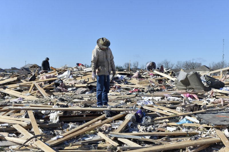 Residents sort through the devastation following a tornado in Washington, Illinois on November 18, 2013. A new report by Brown University says although veterans receive sufficient support in the treatment of PTSD, non-veterans, who may experience trauma through natural disaster, crime or accidents, lack such resources. File Photo by Brian Kersey/UPI