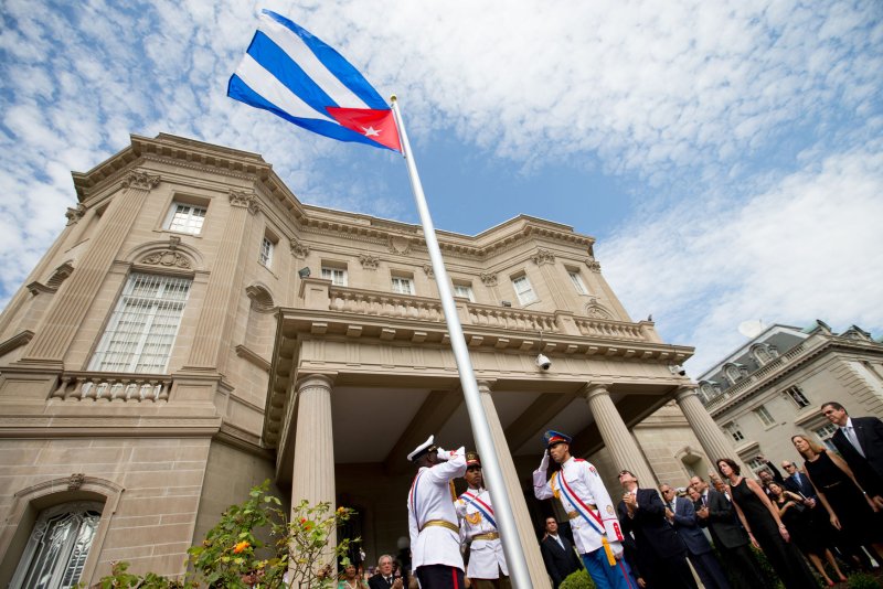 Cuban Foreign Minister Bruno Rodriguez (R) applauds with other dignitaries after raising the Cuban flag over their new embassy in Washington on July 20, 2015. In May, two Cuban diplomats in Washington, D.C., were expelled after an alleged "acoustic attack" on U.S. officials in Havana. Pool Photo by Andrew Harnik/UPI | <a href="/News_Photos/lp/7431658836db363b1e59d235f1bb7dc5/" target="_blank">License Photo</a>