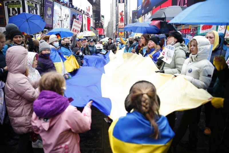 Protesters hold a large flag of Ukraine and umbrellas with the colors of the Ukraine Flag at a Close the Sky March Umbrella Rally in support of Ukraine in Times Square in New York City on Saturday. Photo by John Angelillo/UPI | <a href="/News_Photos/lp/b7bb3d9cae34ece12e73f6b415fea511/" target="_blank">License Photo</a>
