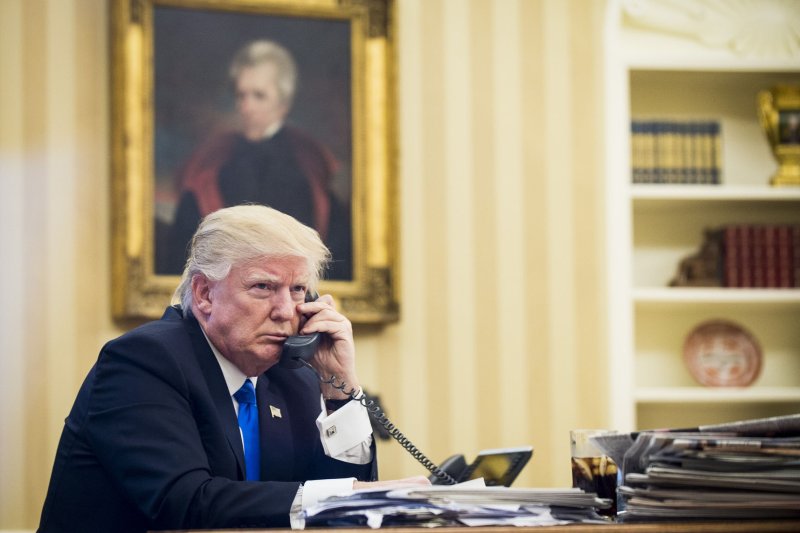 U.S. President Donald Trump speaks on the phone with Australian Prime Minister of Malcolm Turnbull in the Oval Office on Saturday. Photo by Pete Marovich/UPI