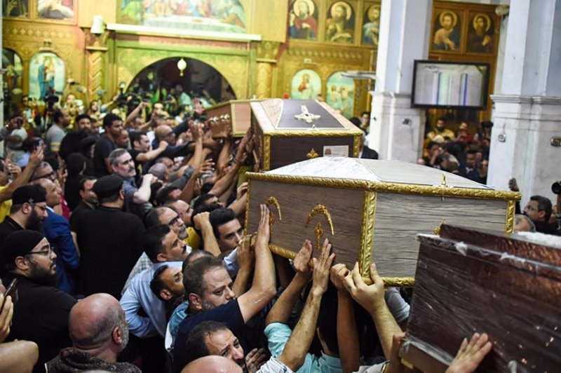People attend a funeral ceremony for victims of the fire at the church of the Blessed Virgin Mary in Giza, Egypt, on Sunday. Flames tore through a packed crowd during morning services at the church near Cairo. Photo by Sayed Hassan/UPI | <a href="/News_Photos/lp/7b942bf4b65179b2370f7b9b56595206/" target="_blank">License Photo</a>