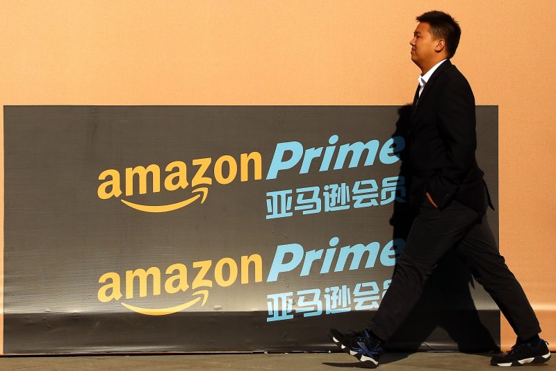 A man walks past an Amazon Prime showroom in downtown Beijing. On Thursday, the company announced a list of 20 cities that are finalists for the location of its second headquarters. Photo by Stephen Shaver/UPI  | <a href="/News_Photos/lp/d13f1801c9316de01767d86df97c3a91/" target="_blank">License Photo</a>