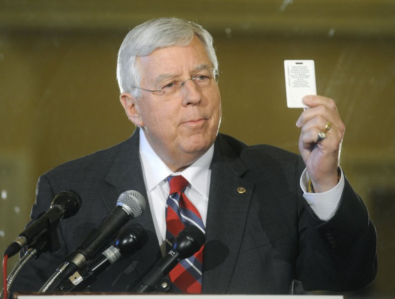 Michael Enzi (R-WY) holds a digital records card replica while speaking on the "Wired for Health Care Quality Act" in Washington on April 2, 2008. The measure would move America's heath care system from a paper based system to a secure electronics based record system. The legislation is projected to save $165 billion. (UPI Photo/Kevin Dietsch)