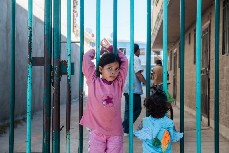 Migrant children stand near the Benito Juarez shelter in Tijuana, Mexico, on November 27. File Photo by Ariana Drehsler/UPI | <a href="/News_Photos/lp/6f199742d85bf7a19d1d8eca264ec2a3/" target="_blank">License Photo</a>