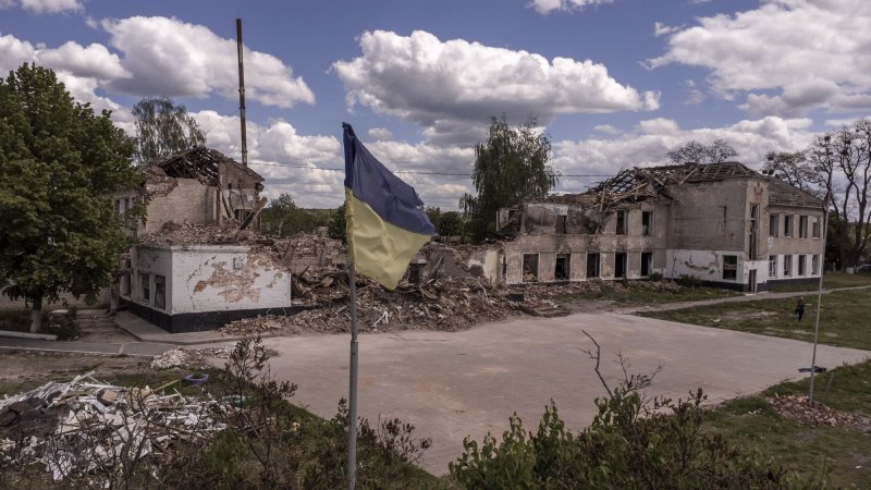 A Ukrainian flag is seen Wednesday in front of Secondary School of Merefa, damaged after Russians shelled it in Merefa, Ukraine, south of Kharkiv. On Thursday, U.S. President Joe Biden announced an additional $100 million in weapons and equipment for the besieged European nations. Photo by Ken Cedeno/UPI | <a href="/News_Photos/lp/799acf70f1882d730fa5092f23c285f7/" target="_blank">License Photo</a>
