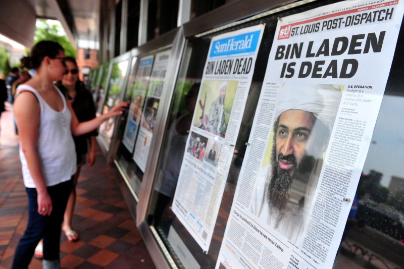 People stop in Washington, D.C., to look at newspaper headlines from around the United States announcing the death of Osama bin Laden on May 2, 2011. The terror leader was killed after nearly a decade of being hunted by U.S. forces. File Photo by Kevindietsch/UPI