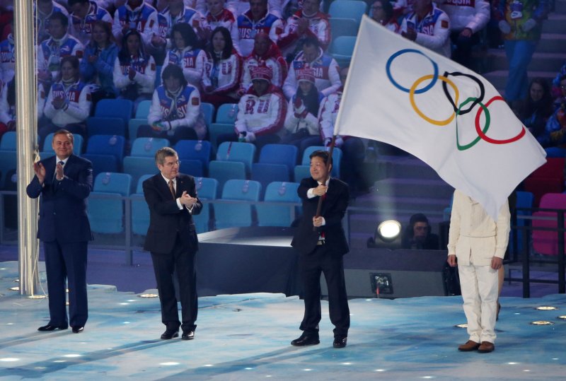 Lee Seok-rae (R), mayor of PyeongChang, Korea receives the Olympic flag from International Olympic Committee President Thomas Bach (C) after it was passed from Sochi Mayor Anatoly Pakhmov during the Closing Ceremony at the Sochi 2014 Winter Olympics on February 23, 2014 in Sochi, Russia. UPI/Kevin Dietsch