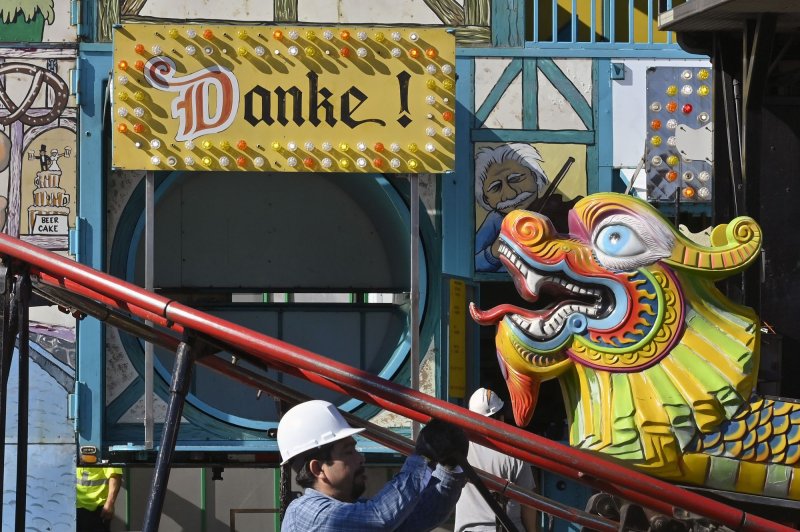 Merchants dismantle their booths Sunday in the wake of a mass shooting Saturday night at the nearby Star Dance Studio, where patrons were celebrating the Lunar New Year. Photo by Jim Ruymen/UPI