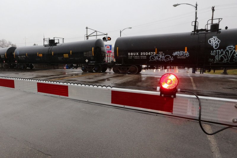 A Norfolk Southern train passes through the center of the village of East Palestine, Ohio, in February after a derailment that forced mass evacuations from the area. A Norfolk Southern train derailed in the town, spilling hazardous chemicals on February 3. Photo by Aaron Josefczyk/UPI