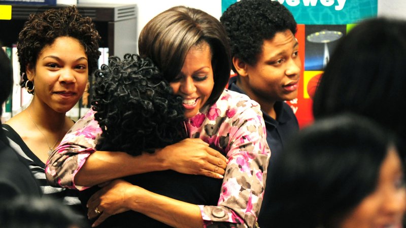 First Lady Michelle Obama hugs a student after speaking to a group at Ballou Senior High School, in Washington on March 30, 2011. This event was part of a Women's History Month mentoring event where prominent women leaders, athletes, business leaders and actresses spoke to Washington, D.C. area students. UPI/Kevin Dietsch