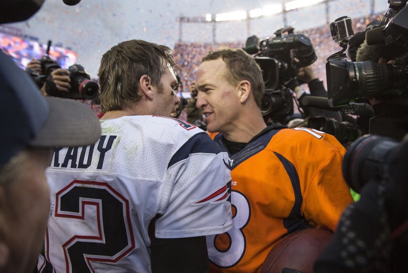 Tom Brady (L) congratulates Peyton Manning after the AFC Championship game at Sport Authority Field at Mile High in Denver on January 24, 2016. Photo by Gary C. Caskey/UPI