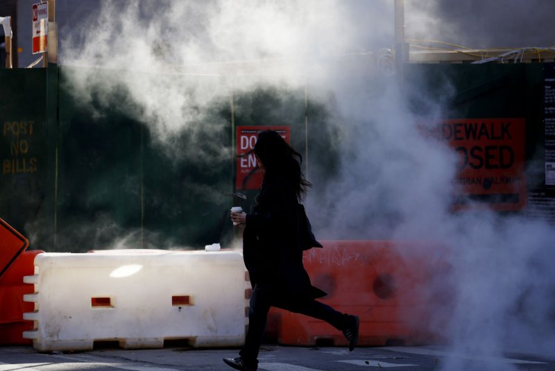 A pedestrian crosses an intersection as steam is released on the streets of New York City in December. While the city has seen precipitation this winter, it has primarily come in the form of rain instead of snow due to abnormally warm temperatures. File Photo by John Angelillo/UPI