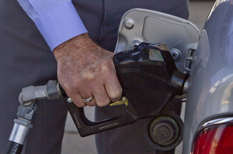 A motorist pumps gas in Denver on April 15, 2011. Gas and food price increases will affect the nation's economic growth in the coming months. Gasoline jumped 5.6 percent last month and has risen nearly 28 percent in the past year. Consumers paid an average price of $3.81 a gallon nationwide on Friday according to the travel group AAA. UPI/Gary C. Caskey