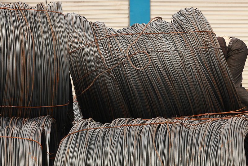 A Chinese worker prepares to help load massive bundles of steel cable on to a truck in Lijiang, northern Yunnan Province, on September 30, 2012. The United States is threatening massive tariffs on steel exported to the United States. File Photo by Stephen Shaver/UPI
