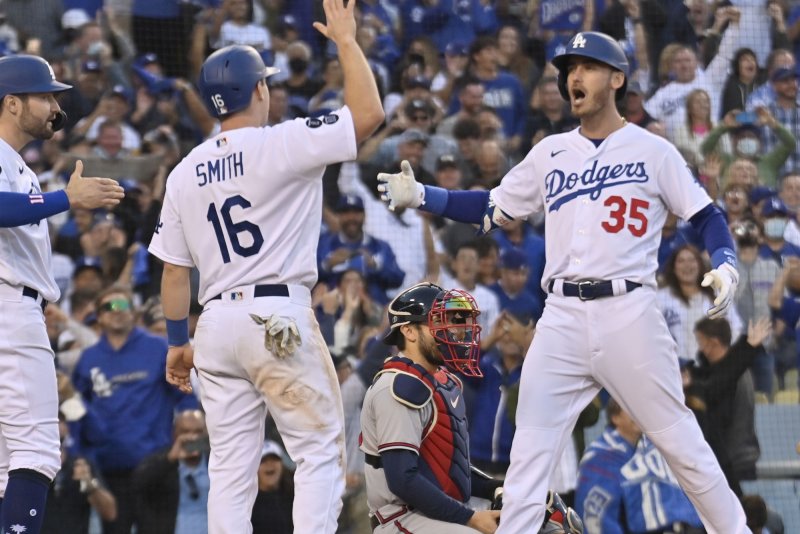 Los Angeles Dodgers first baseman Cody Bellinger (35) celebrates with teammates Will Smith (16) and A.J. Pollock (L) after hitting a three-run home run against the Atlanta Braves during the eighth inning in Game 3 of the NL Championship Series on Tuesday at Dodger Stadium in Los Angeles. Photo by Jim Ruymen/UPI