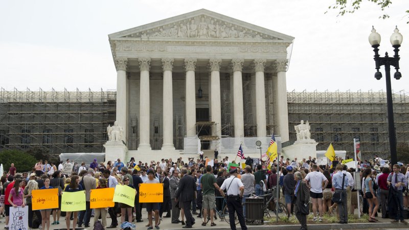 Protesters gather in front of the U.S. Supreme Court as they wait for the court's ruling on the Affordable Care Act on June 28, 2012 in Washington, D.C. The court upheld a majority of President Obama's health care reform bill, ruling in a 5-4 decision to keep the individual insurance mandate. UPI/Kevin Dietsch