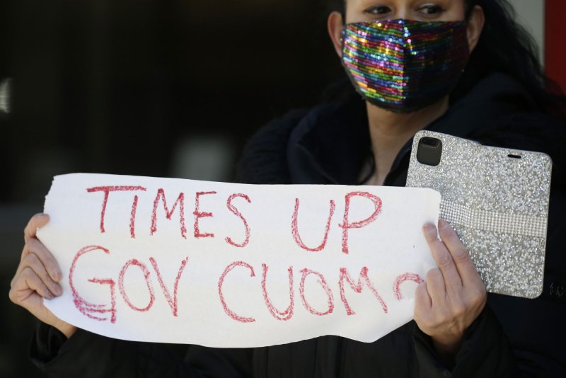 A protester holds a sign that reads, "Time's up Gov. Cuomo," on Sunday outside the governor's Manhattan office in New York City. Photo by John Angelillo/UPI | <a href="/News_Photos/lp/1d55b9b030e1d738bf59a7bb00e785b9/" target="_blank">License Photo</a>