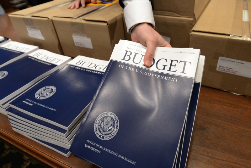 Adam Kamp, chief clerk for the Senate Budget Committee unpacks boxes of the president's FY2015 budget proposal for distribution to Senate staff on Capitol Hill March 4, 2014, in Washington D.C. (UPI/Molly Riley) | <a href="/News_Photos/lp/66930cf579b9726e1e78efd0a67d0564/" target="_blank">License Photo</a>