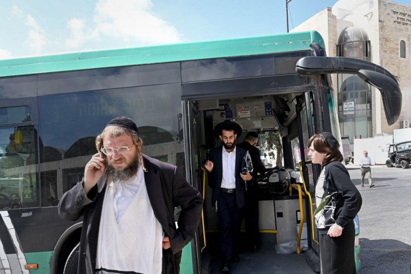 Ultra-Orthodox Jews ride an Israeli Egged bus near the Western Wall in the Old City of Jerusalem on Sunday. Early Sunday morning, eight people were wounded when a Palestinian shot at a bus and at people waiting for a bus near the Western Wall. Four American citizens were injured in the attack and a pregnant woman shot in the stomach had an emergency C-section. Photo by Debbie Hill/UPI | <a href="/News_Photos/lp/739f850b8d065aa784781b937028634f/" target="_blank">License Photo</a>