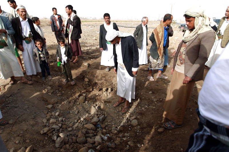 Local residents gather around a crater left following a reported airstrike near the Yemeni capital, Sanaa, on March 28, 2015 -- the third day of Saudi-led coalition airstrikes against Houthi rebels. On Saturday, a Saudi-led airstrike reportedly killed 30 people, mostly civilians, in a district northeast of Sanaa. Photo by Mohammad Abdullah/UPI