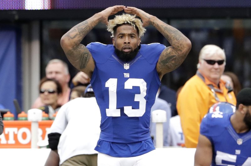 New York Giants Odell Beckham Jr. celebrates after scoring on 75 yard touchdown catch in the 3rd quarter against the Baltimore Ravens in week 6 of the NFL at MetLife Stadium in East Rutherford, New Jersey on October 16, 2016. Beckham Jr. received a 15 yard unsportsman like conduct penalty for taking his helmet off. File Photo by John Angelillo/UPI | <a href="/News_Photos/lp/e136365c6931ac2608400cd6cb994c14/" target="_blank">License Photo</a>
