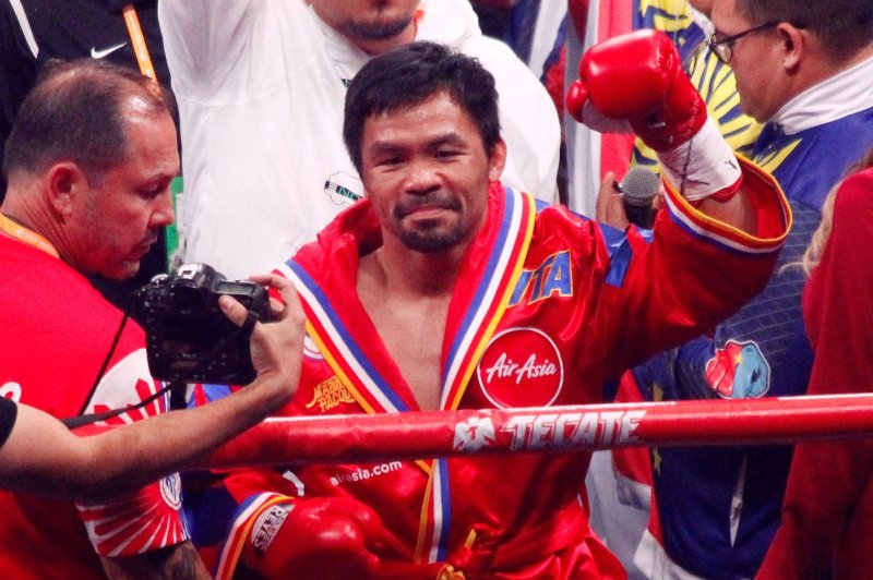 Boxer Manny Pacquiao (R), who retired early Wednesday, posted a record of 62 wins, eight losses and two draws over his 26-year tenure in the sport. File Photo by James Atoa/UPI