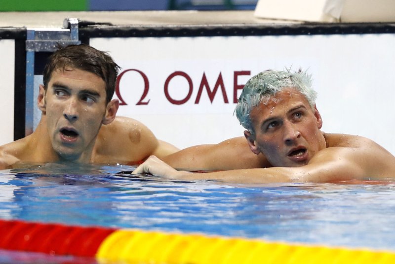 Michael Phelps of the United States remains in the water with Ryan Lochte after winning the gold medal in the Men's 200m individual medley with a time of 1:54.66 at the Olympic Aquatics Stadium at the 2016 Rio Summer Olympics in Rio de Janeiro, Brazil, on August 11, 2016. Phelps wins his 22nd gold medal. Photo by Matthew Healey/UPI