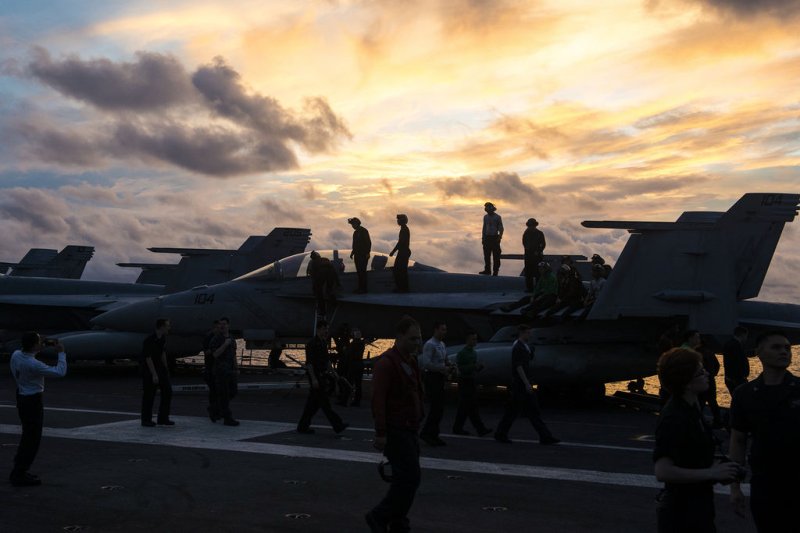 Sailors stand on an F/A-18F Super Hornet aboard the USS Ronald Reagan (CVN 76) to get a better view of the fireworks during the ship's Independence Day celebration on July 4, 2016, in the South China Sea. Ronald Reagan, the Carrier Strike Group Five (CSG 5) flagship, is on patrol in the U.S. 7th Fleet area of responsibility supporting security and stability in the Indo-Asia-Pacific region. File Photo by James Mullen/U.S. Navy/UPI