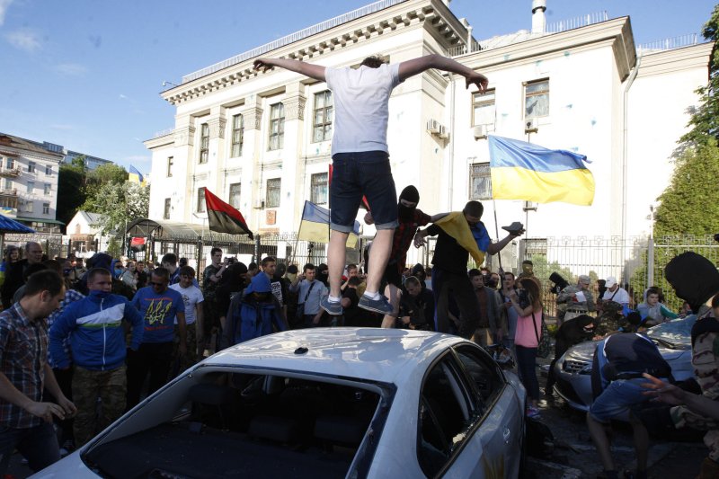 Protesters destroy cars with diplomatic plates outside the Russian Embassy in Kiev on June 14, 2014. UPI/Ivan Vakolenko
