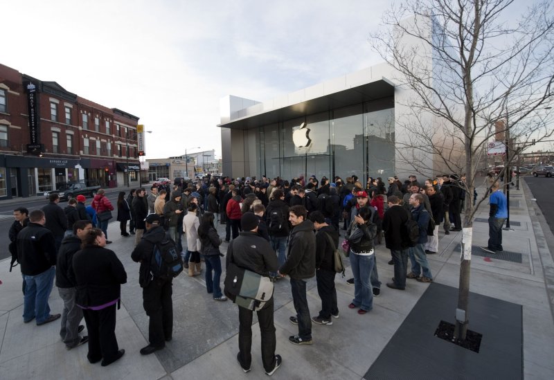 Customers wait in line to purchase the new iPad 2 outside of the Apple Store's Lincoln Park location on March 11, 2011 in Chicago. UPI/Brian Kersey