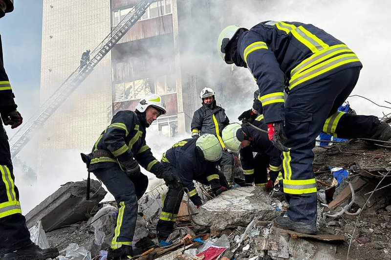 Rescuers and residents search for survivors in the rubble next to a damaged residential building in Uman, south of Kyiv on Friday, after Russian missile strikes targeted several Ukrainian cities overnight. The biggest Russian air raids in months on several cities have killed at least 18 people, including three children, the Ukrainian emergency service said. Photo courtesy of the State Emergency Service of Ukraine