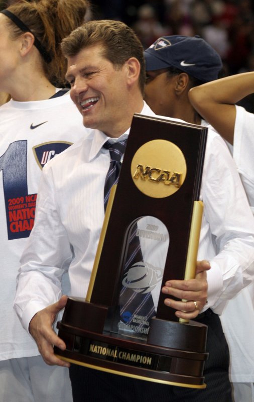 Connecticut Huskies head basketball coach Geno Auriemma holds the championship trophy after his team defeated the Louisville Cardinals 76-54 to win the championship game of the Women's Final Four at the Scottrade Center in St. Louis on April 7, 2009 (UPI Photo/Bill Greenblatt)