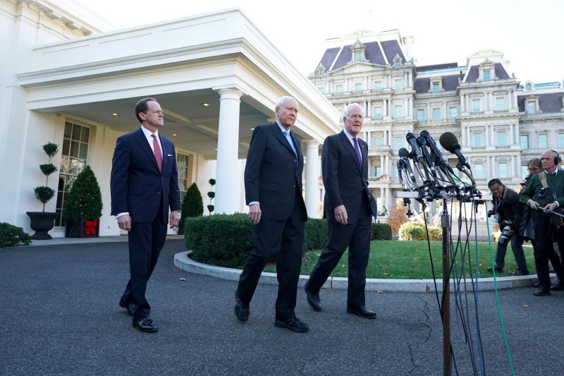 Senate Finance Committee Chairman Orrin Hatch (C), R-Utah, Sen. John Cornyn (R), R-Texas, and Sen. Pat Toomey, R-Pa., leave the White House Monday to speak to news media following a meeting with President Donald Trump on the Republican tax bill. Photo by Kevin Dietsch/UPI
